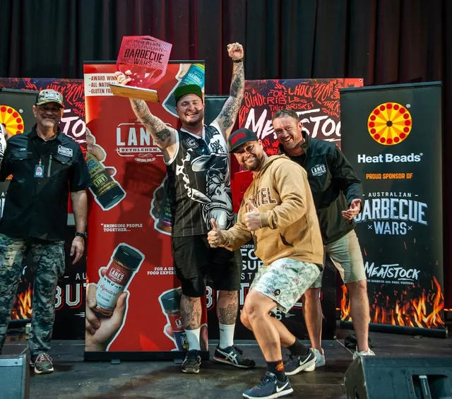 Steven Cook celebrating at Meatstock Sydney Grand Championship with Cook Cartel BBQ team