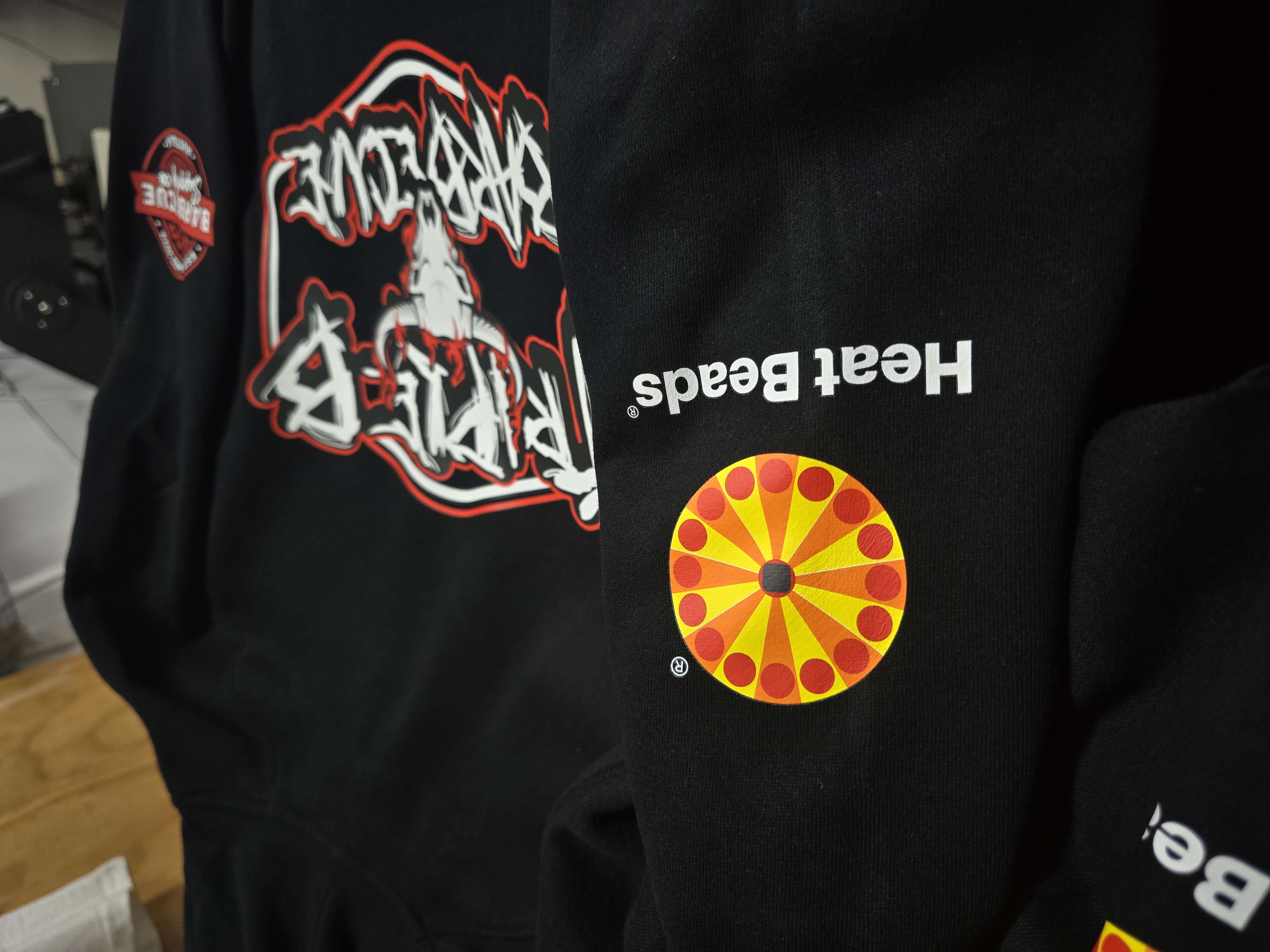 Custom printed Cook Cartel event hoodies with sponsor brands