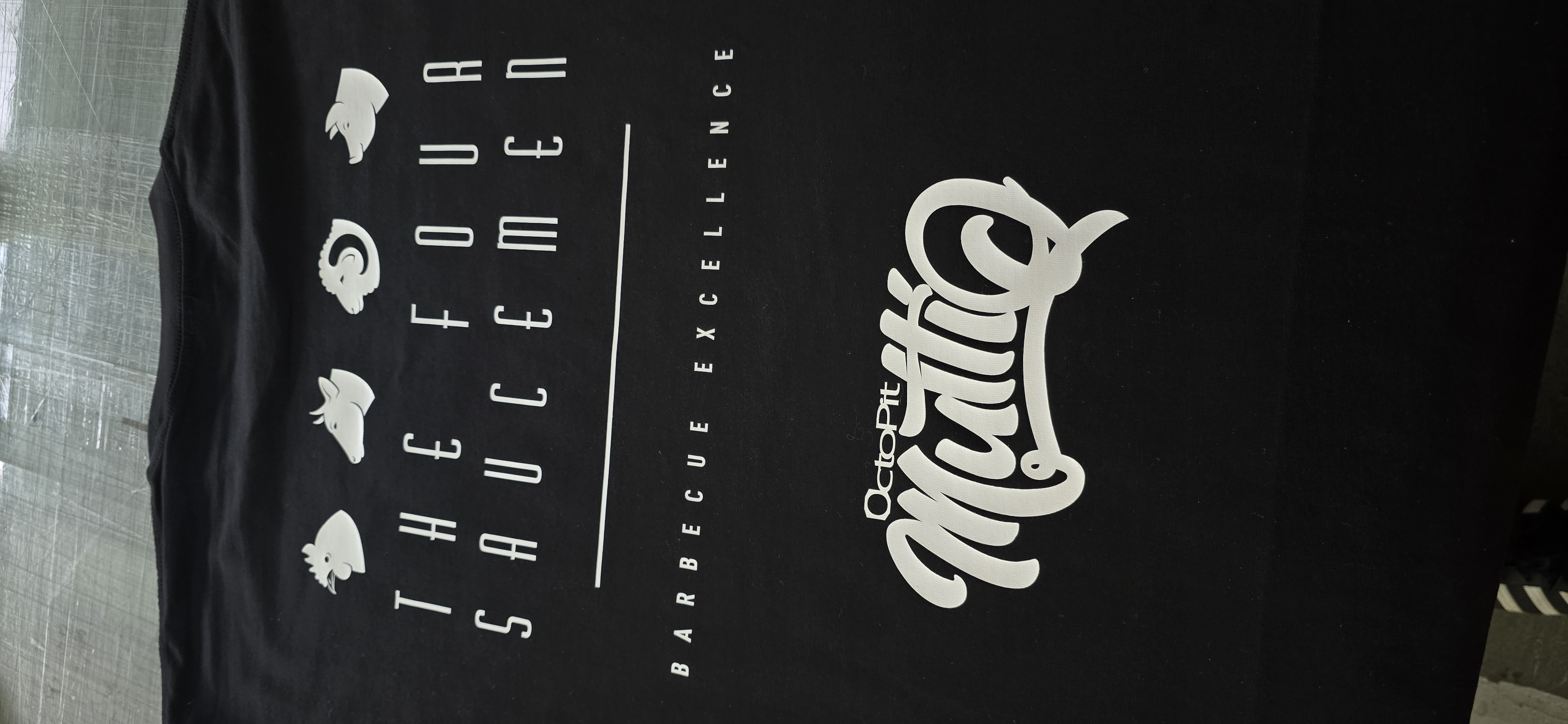 Stacks of custom-printed business and team t-shirts from CDP Henderson