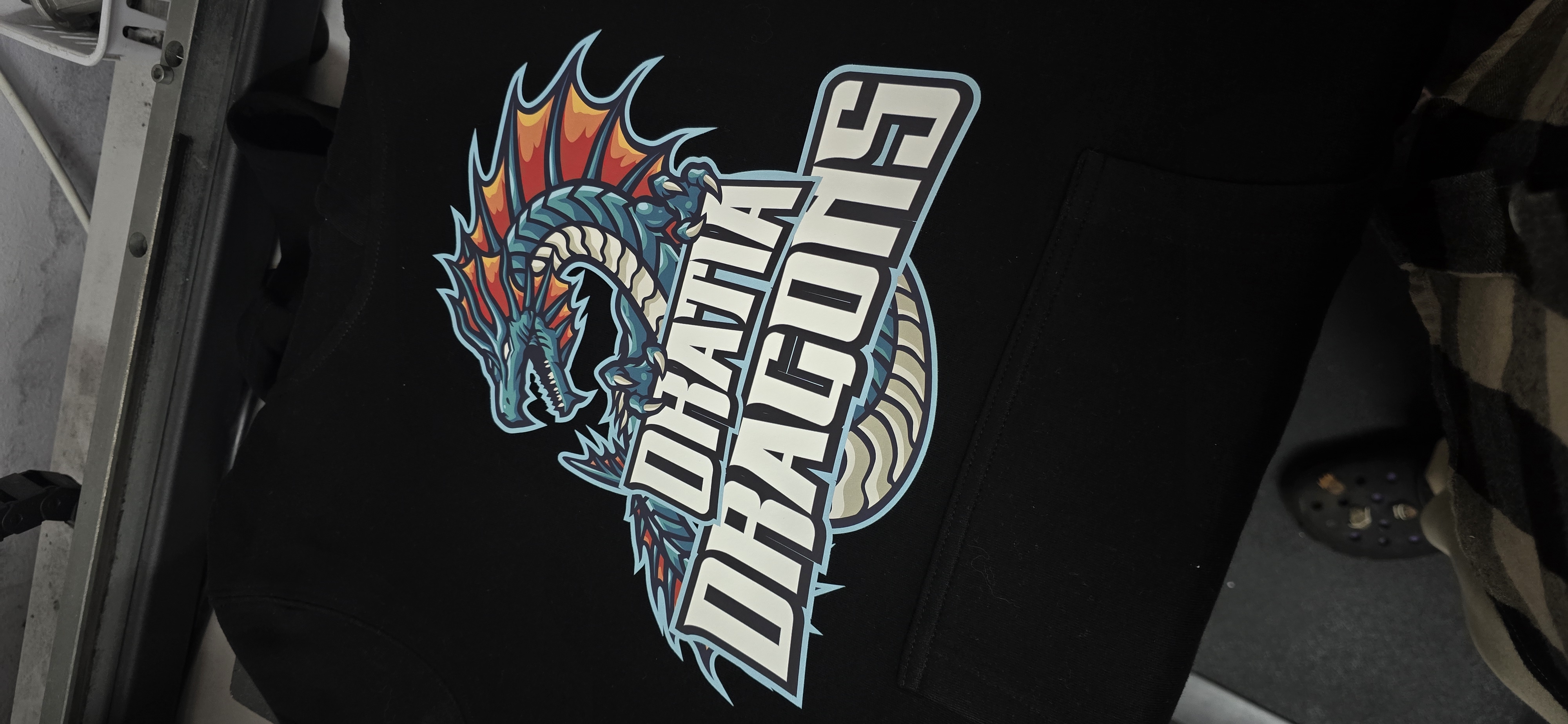 Custom printed hoodies on dark fabric with vivid colours